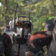 The Bad Batch's Echo, Tech, and Hunter scope out an Imperial target from a forest edge in their full armor.